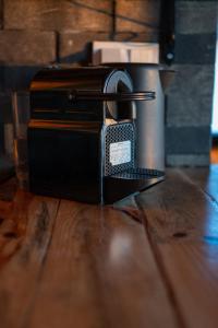 a toaster sitting on top of a wooden table at Danube Retreat in Belgrade