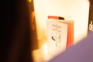 a book is sitting on a shelf in a room at Les Jolies Nuits - À la folie, Loft & Spa in Montrevault