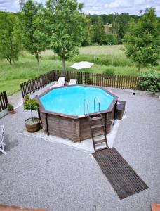 a swimming pool with a chair next to it at Charming Gite with pool - peaceful coumtryside in Charente in Exideuil