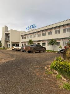 a hotel with cars parked in front of it at Plaza Hotel in Mineiros