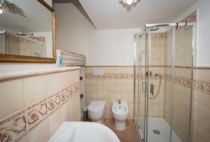 a bathroom with a toilet and a glass shower at Residence Fusconi in Norcia +34 photos