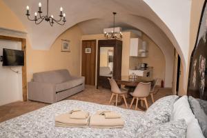 a living room with a bed with two towels on it at Residence Fusconi in Norcia