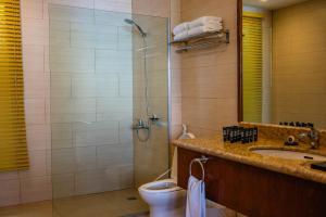 a bathroom with a shower and a toilet and a sink at El Mar Resort in Sampong +32 photos