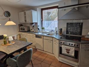 a kitchen with a table and a stove top oven at Rebenhaus St Martin in Sankt Martin