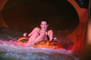 a woman sitting on an inner tube in the water at Break Sokos Hotel Flamingo in Vantaa