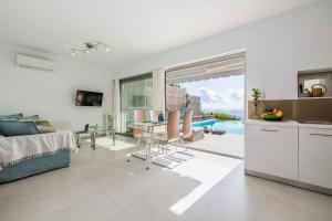 a kitchen and living room with a view of the ocean at Villa Harmonie in Achlia