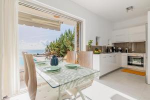 a kitchen with a table and a view of the ocean at Villa Harmonie in Achlia
