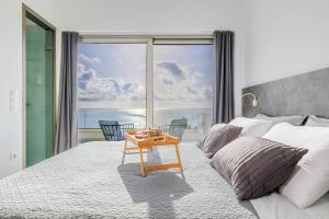 a bedroom with a bed with a view of the ocean at Villa Harmonie in Achlia +30 photos
