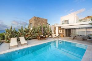 a villa with a swimming pool and a patio at Villa Harmonie in Achlia