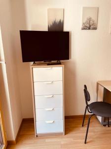 a tv sitting on top of a dresser with a television at Studio Vitalis in Zermatt +6 photos