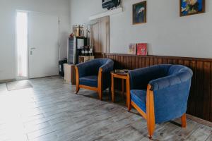 a waiting room with two blue chairs and a table at Zur Weinlaube in Mönchhof