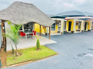 a building with a table and chairs in front of it at Druza’s guest house in Rustenburg