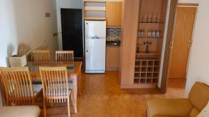 a kitchen with a dining table and a refrigerator at 2-Bedroom Chalet for Ski and Summer in Kfardebian