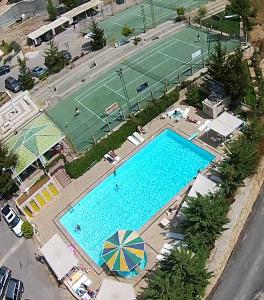 an overhead view of a tennis court and a pool at 2-Bedroom Chalet for Ski and Summer in Kfardebian