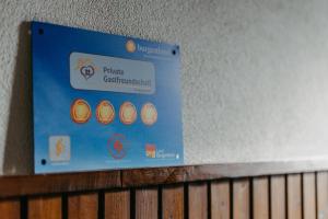 a blue sign on a wall above a wooden shelf at Zur Weinlaube in Mönchhof