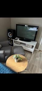 a living room with a coffee table and a tv at Casa Brekka in Bamble +17 photos