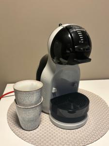 a coffee maker and a cup on a table at Casa Brekka in Bamble
