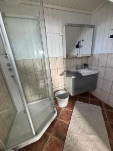 a bathroom with a shower and a sink at Casa Brekka in Bamble