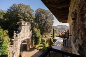 a balcony of a house with a view of a garden at Palacio de Arce in Puente Arce +39 photos