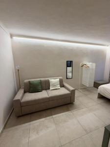a couch with two pillows on it in a room at Casa Bago in Ivrea