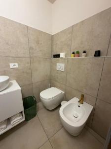 a bathroom with a toilet and a sink at Casa Bago in Ivrea