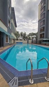 a large blue swimming pool in a building at Jenn Suites - Nakuru Town in Nakuru