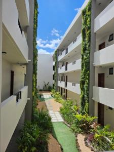 an internal courtyard of a building with plants at Friendly & Warm in Tamarin