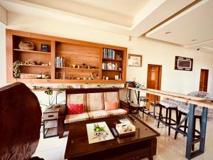 a living room with a couch and a bar at 日月潭 讀好聚民宿 2-22人 一次只接待一組 in Yuchi