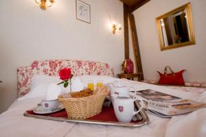 a tray with tea set on top of a bed at Resort Golf Château de Salles in Vezac +1 photo