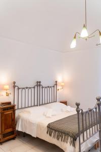 a bedroom with a bed and a wooden night stand at Il Da Vinci Apartment in Giovinazzo