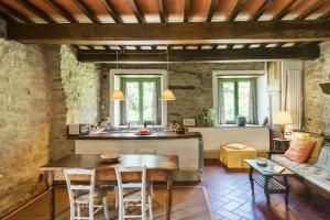 a kitchen and living room with a wooden table at Romantic Apartment With Tuscan Valley Views in Londa