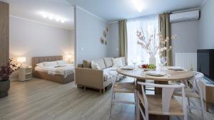 a living room with a dining room table and a couch at Baltic Line - Pomerania in Gdańsk