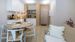 a kitchen and living room with a table and chairs at Baltic Line - Pomerania in Gdańsk +7 photos