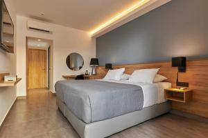 a bedroom with a large bed in a room at Sentido Amounda Bay in Amoudara Herakliou +37 photos