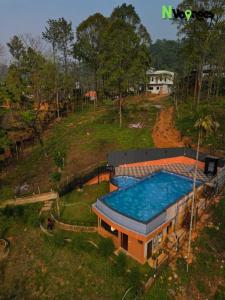 an overhead view of a house with a swimming pool at Nvoyages Wayanad in Wayanad