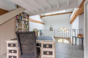 an attic office with a desk and a book shelf at La Ruche - Maison 7p avec Jardin in Saint-Lucien