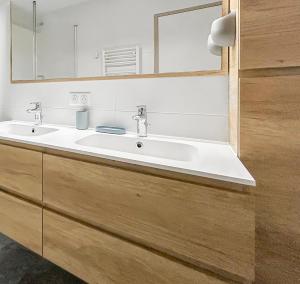 a bathroom with a white sink and a mirror at La forêt, T3 Design, Parking, Face à la Gare in Grenoble +14 photos