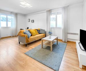 a living room with a couch and a table at La forêt, T3 Design, Parking, Face à la Gare in Grenoble