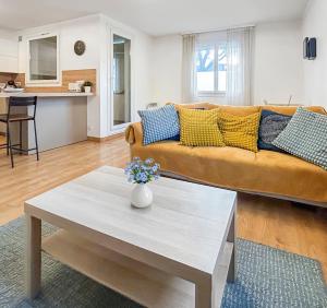 a living room with a couch and a coffee table at La forêt, T3 Design, Parking, Face à la Gare in Grenoble