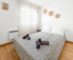 a bedroom with a bed with two slippers on it at La forêt, T3 Design, Parking, Face à la Gare in Grenoble