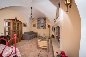 a living room with a table and a couch at Residence Fusconi in Norcia