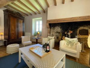 a living room with a table with wine bottles on it at Paillé in Artiguelouve