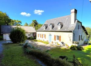 a large white house with a gray roof at Paillé in Artiguelouve