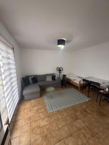 a living room with a couch and a table at Appolo in Vouvry