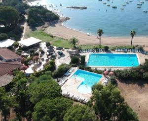 an aerial view of a resort with a pool and a beach at Village Naturiste La Chiappa in Porto-Vecchio +21 photos