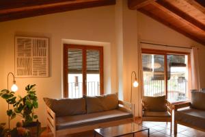 a living room with two couches and a table at Mas Salvador Rural Experience in Llagostera