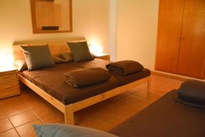 a bedroom with a bed with two pillows on it at Mas Salvador Rural Experience in Llagostera