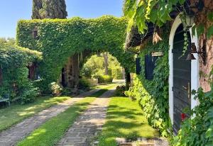 an ivy covered building with a pathway in a yard at Parco delle Nazioni - Relax Grand Resort in Castel di Decima