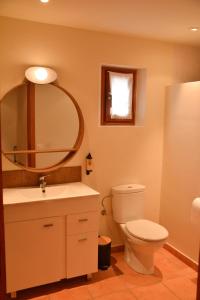 a bathroom with a toilet and a sink and a mirror at Mas Salvador Rural Experience in Llagostera +73 photos