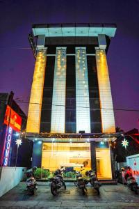 a building with motorcycles parked in front of it at Qubehotelinn in Cochin +24 photos